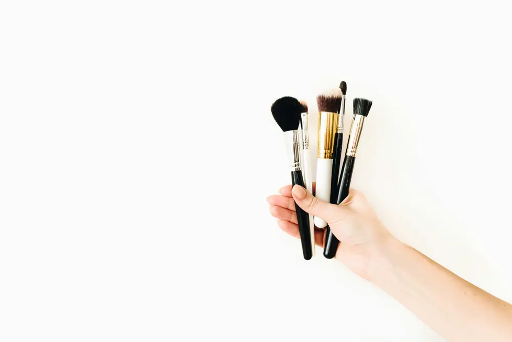 Makeup artist holding a set of professional brushes